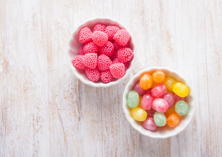 colors candies in a bowl on a wooden table