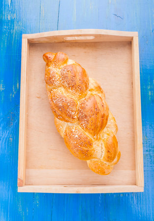 challah on the blue wooden table. studio shot