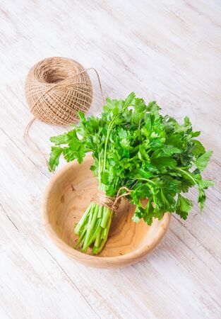 leaf of parsley on a white wooden table. studio shotの写真素材