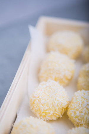 Homemade Coconut Pralines in a wooden box. studio shot.
