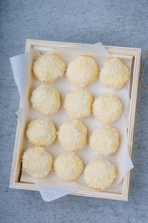 Homemade Coconut Pralines in a wooden box. studio shot.
