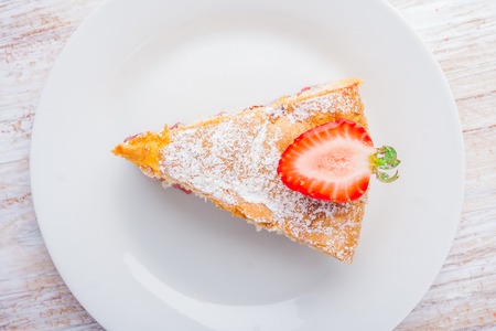 cake with strawberries on a white plate. studio shotの写真素材