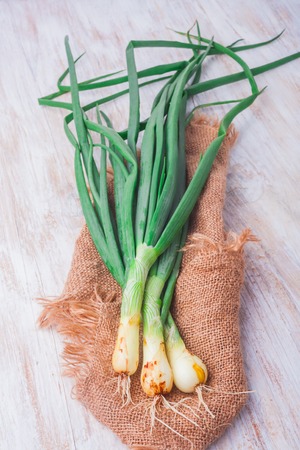 young onions with chives on a white wooden table. studio shotの写真素材