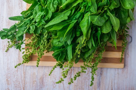 fresh spinach leaves on a wooden kitchen board. studio shotの写真素材