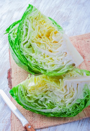 Fresh raw green cabbage on a wooden table, studio shotの写真素材