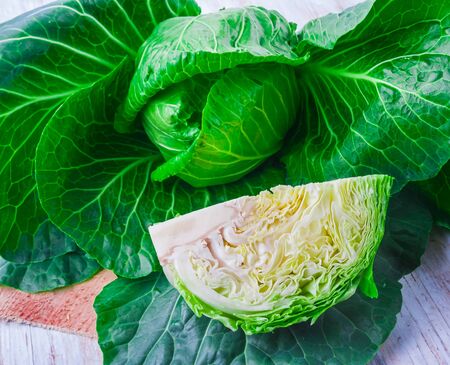Fresh raw green cabbage on a wooden table, studio shotの写真素材