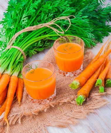 fresh carrot juice in glasses on table. studio shotの写真素材