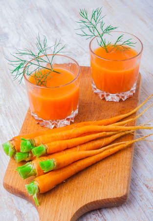 fresh carrot juice in glasses on table. studio shotの写真素材