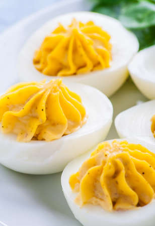 Stuffed eggs on a white plate. studio shotの写真素材