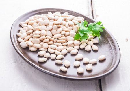 Dry bean grain on a dark plate. studio shotの写真素材