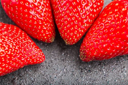 Fresh red trawberries on black background. studio shotの写真素材