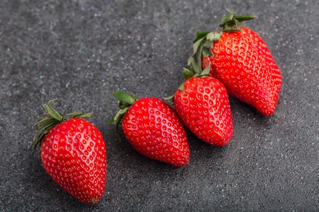 Fresh red trawberries on black background. studio shotの写真素材