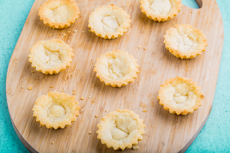Fresh lower part muffins without cream on a wooden board. studio shotの写真素材