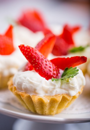Delicious cupcake with whipped cream and fresh strawberriesの写真素材