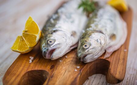 Fresh fish trout on the kitchen board. studio shotの写真素材