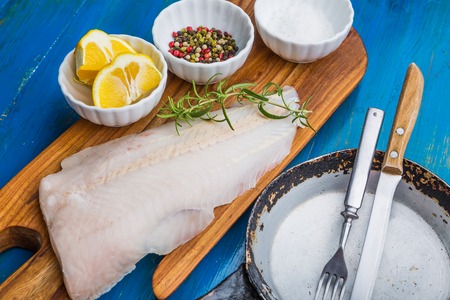 Raw fish fillets for frying on pan. kitchen composition.の写真素材