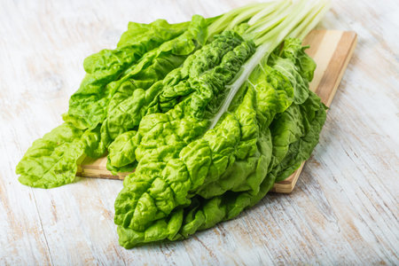 Fresh beet leaf on white wooden table. studio shot
