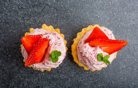 Two small biscuits with strawberries and sweet creamの写真素材