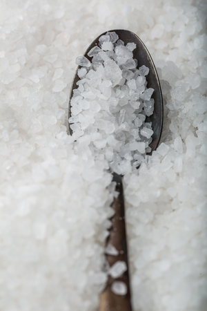 white sea salt on a old spoon. studio shotの写真素材