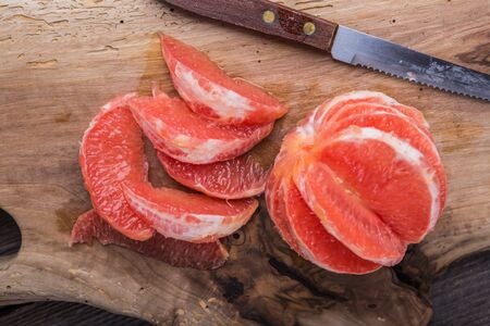 grapegruit pieces on the kitchen board. studio shotの写真素材