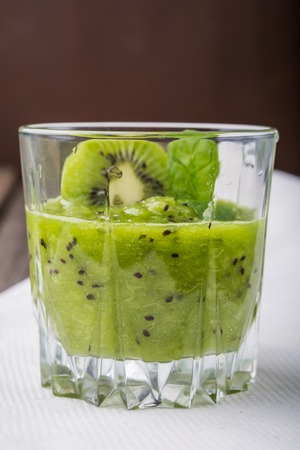smoothie with kiwi and fresh mint in glass. studio shotの写真素材