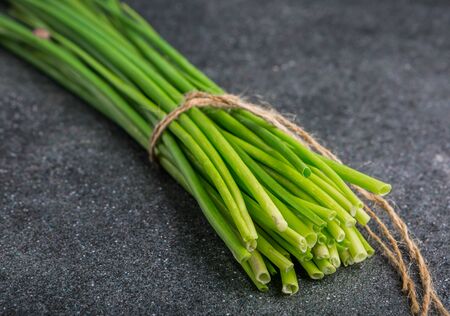 bunch of fresh chives on a table. studio shotの写真素材