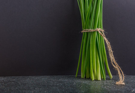 bunch of fresh chives on a table. studio shotの写真素材