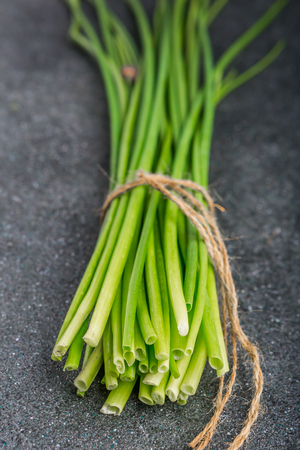 bunch of fresh chives on a table. studio shotの写真素材
