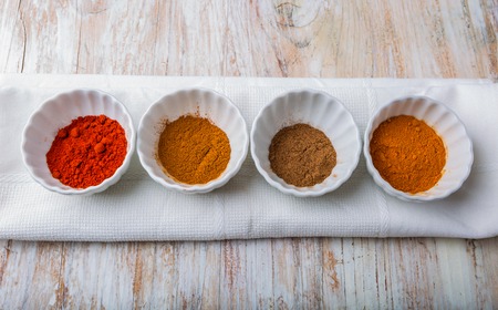 Various kinds of spices on wooden table. studio shotの写真素材