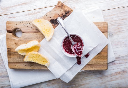Toasts with homemade raspberry jam on wooden table. studio shotの写真素材