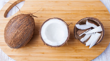 Chopped coconuts on white wooden table