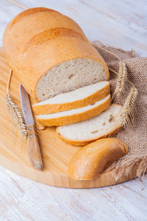 fresh white loaf of bread on cutting board