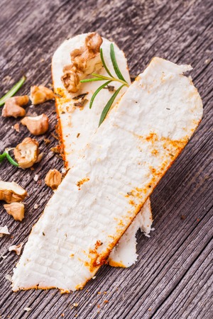 Goat Cheese with pepper crust on old wooden tableの写真素材