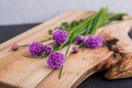 bunch of fresh chives on a wooden table