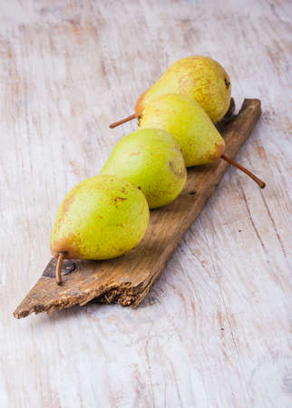 Fresh pears on a old boardの写真素材