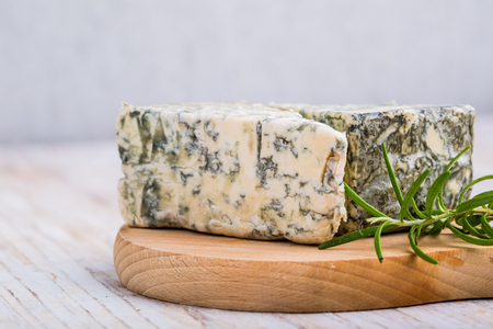 Blue cheese and rosemary on wooden backgroundの写真素材