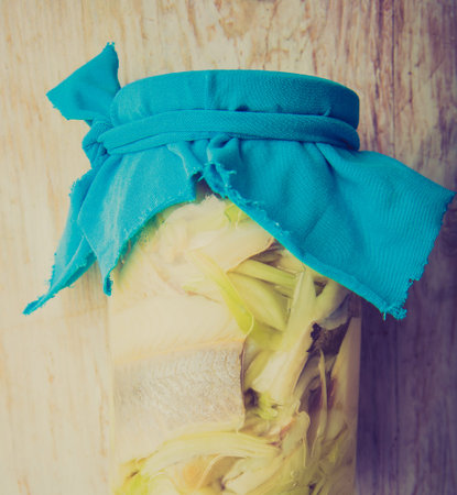 Vintage photo of herring with onion in a jarの写真素材