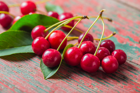 Fresh cherries on old wooden table. studio shotの写真素材