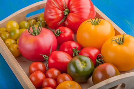 Assorted varieties of ripe tomato on table. studio shotの写真素材
