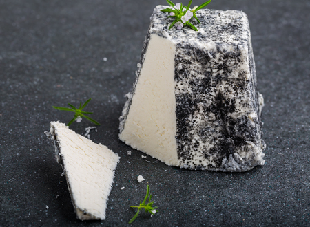 Goat cheese Valencay in france on a black backgroundの写真素材