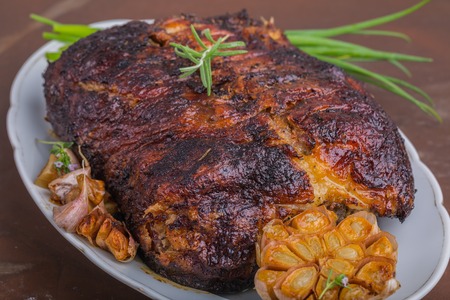 duck roasted with herbs on white plateの写真素材