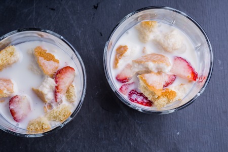 homemade desert with yogurt, chopped cookies and fresh strawberryの写真素材