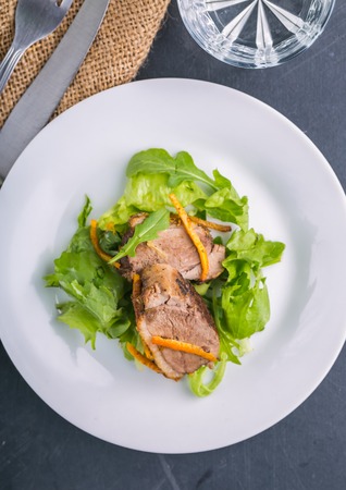 Roasted duck breast in orange on lettuceの写真素材