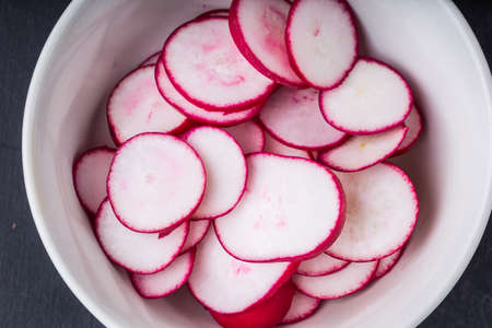 Radish slices in a white bowl, studio shotの写真素材