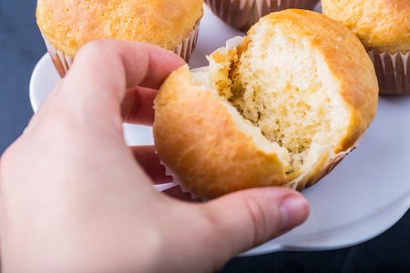 Homemade yeast buns on white plate on black tableの写真素材