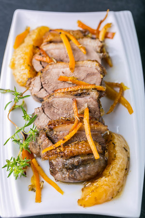 Roasted duck breast in orange on the plateの写真素材