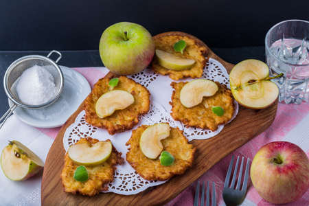 Pancakes with apples and fresh mint on black tableの写真素材