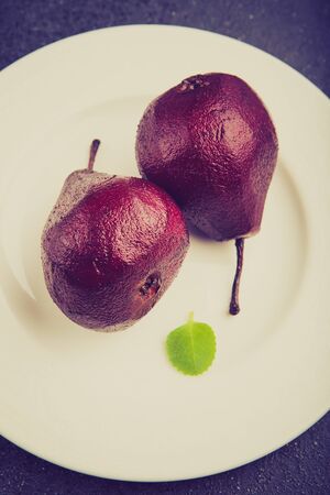 Vintage photo of pears cooked in red wineの写真素材