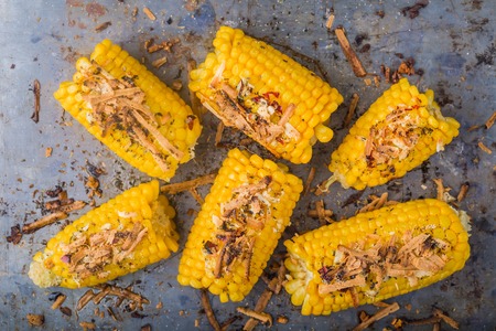 Roasted sweet corn on the cob on metal backgroundの写真素材