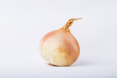 Ripe onion isolated on a white background, studio shotの写真素材